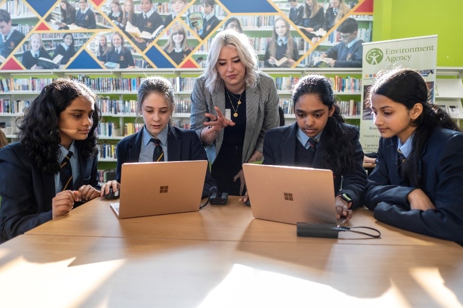 An instructor leads four students on laptops in the Save the Ocean challenge