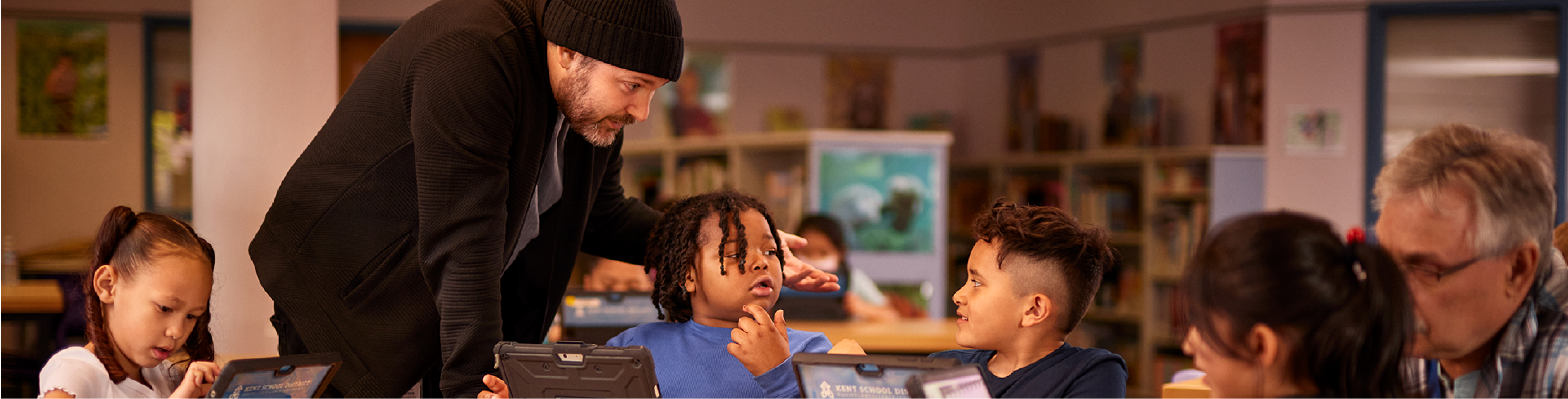 Teacher helping three students