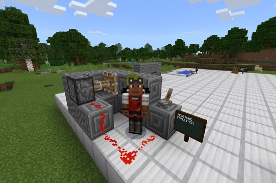 A Minecraft character demonstrates building with redstone in Minecraft: Education Edition
